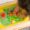 Glo Pals, OUTLET Postać do kąpieli Elmo - zestaw z dwiema kostkami sensorycznymi świecącymi w wodzie